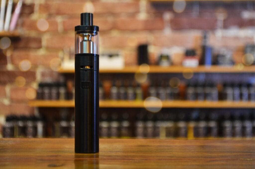 Electronic cigarette on a background of vape shop. E-cigarette for vaping.